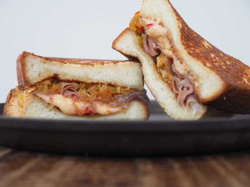 gardenandgun's tweet photo. Husk Nashville’s grilled country ham and pimento cheese sandwich hits all the right Southern flavor notes, including a burst of chow chow to brighten things up. Get the recipe here: https://t.co/Je6m4RJYDL https://t.co/V12wr89Neo