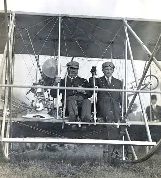 President Theodore Roosevelt and Arch Hoxsey seated in a Wright Type AB in St. Louis, preparing for the first presidential flight in history, 1910