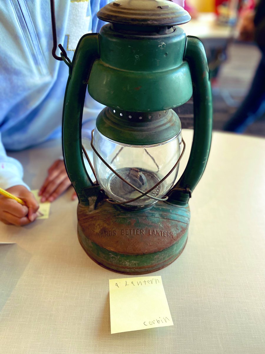 2nd grade students actively engaged in inquiry through an artifact gallery walk activity in the library
