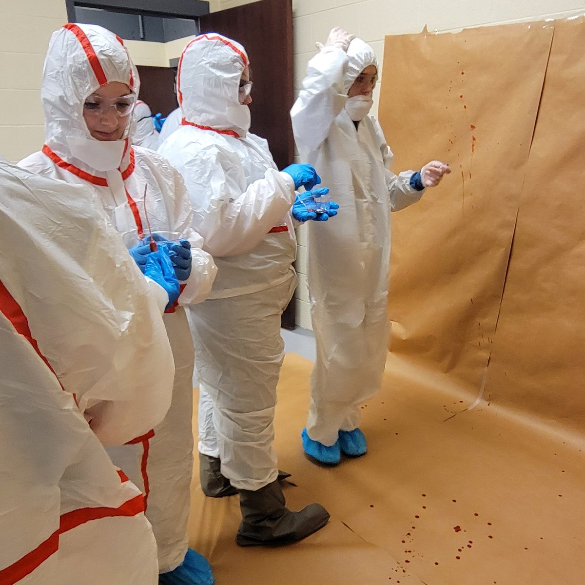 CollinsCTC's tweet photo. Our Public Safety students learn blood spatter analysis w/PPE. Topics include pattern recognition, impact direction, cast-off, and convergents to aid crime scene reconstitution. #CCTCtech #CCTCworks https://t.co/CfUVVxLNua