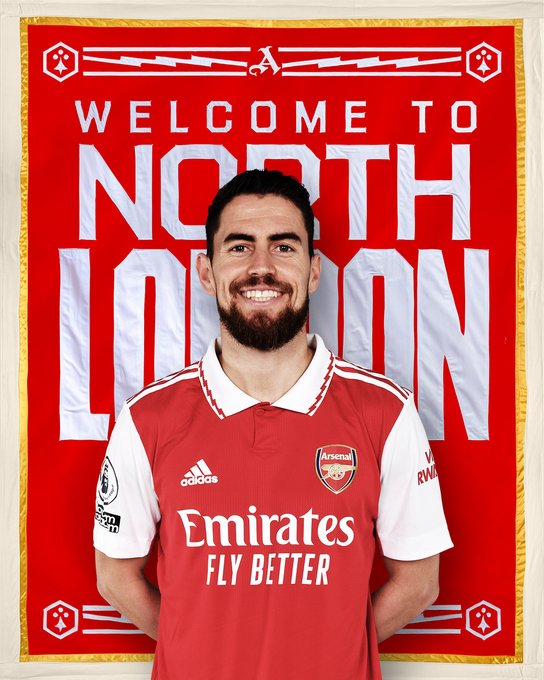 An image of new Arsenal signing, Jorginho, standing in front of a 'Welcome to north London' banner