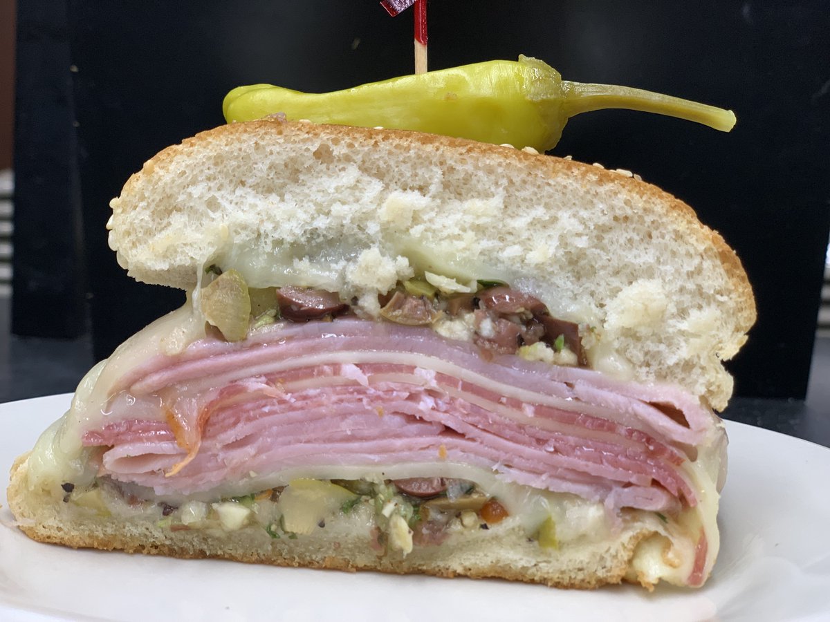 WelchDining's tweet photo. A #NOLA #BonusBite

The Muffaletta is a sandwich composed of ham, salami, spicy Italian ham, provolone, mozzarella, and an olive salad on sesame seed bread. https://t.co/xSVPT1HlQT