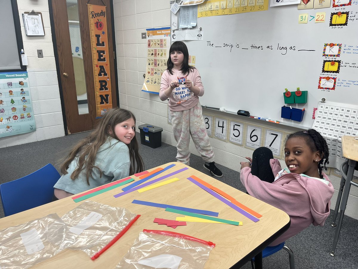Fourth graders show how they can make multiplicative comparisons using construction paper strips. They answered: How many times as long? How do you know? #LongfellowBears #D97