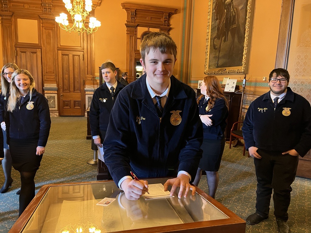 IowaSOS's tweet image. It’s @iowaffa Association Day on the Hill! While visiting the Iowa Capitol, FFA members met with legislators &amp;amp; many stopped by my office. Several registered to vote atop the case containing the original 1857 Iowa Constitution! The future of agriculture is BRIGHT! #IowaAg #IowaFFA