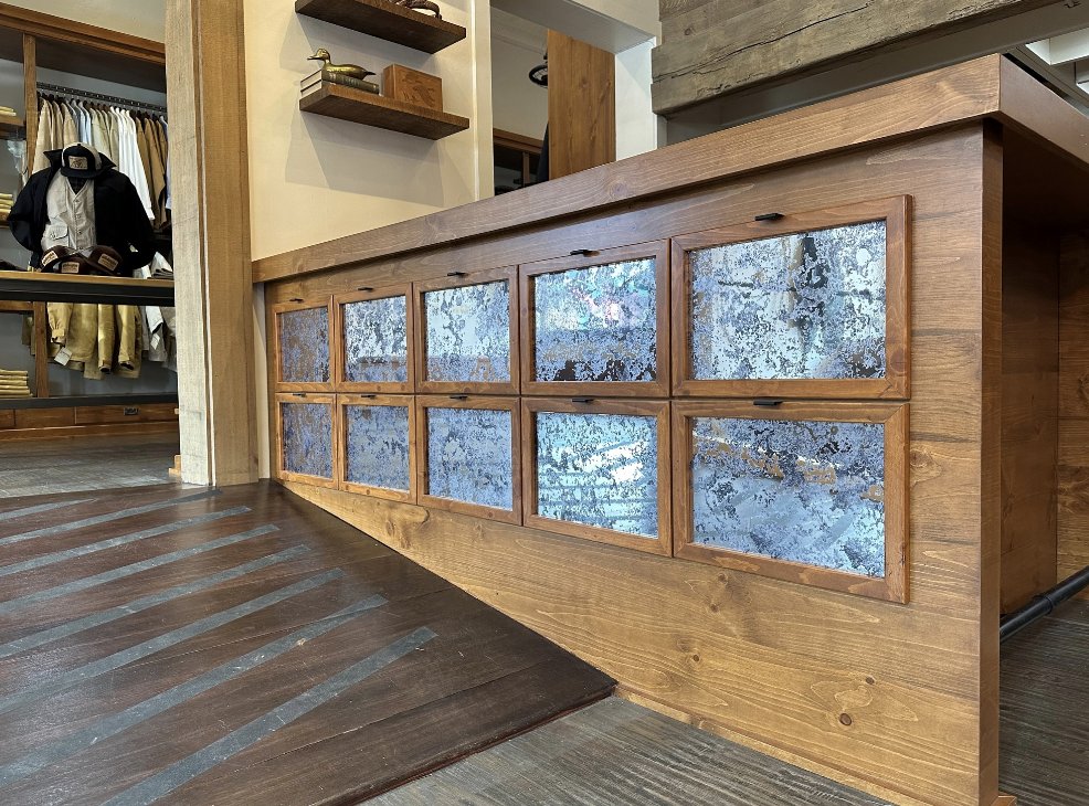 Here are some project photos from #SchaeferOutfitter in the #Stockyards... can you guess what we did in these photos?

We installed the #vinyl in each of those squares on the checkout counter and the windows above to make it look like a vintage mirror! Ummm, how cool is that?!