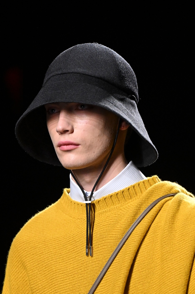 Dior's tweet photo. From the Thames to the Seine and the Channel in between, water is a repeat reference for #DiorWinter23 by Kim Jones https://t.co/jwPhBTg6N1, as oilskin-style yellow outerwear and sweaters accessorized with sou'wester hats. https://t.co/DPkyC2qkWJ