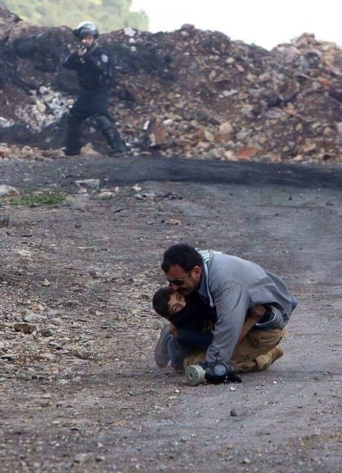 PalestineCultu1's tweet photo. The Palestinian struggle on a daily basis. A father protecting his son from being assassinated in cold blood... https://t.co/5BQlKLjhLY