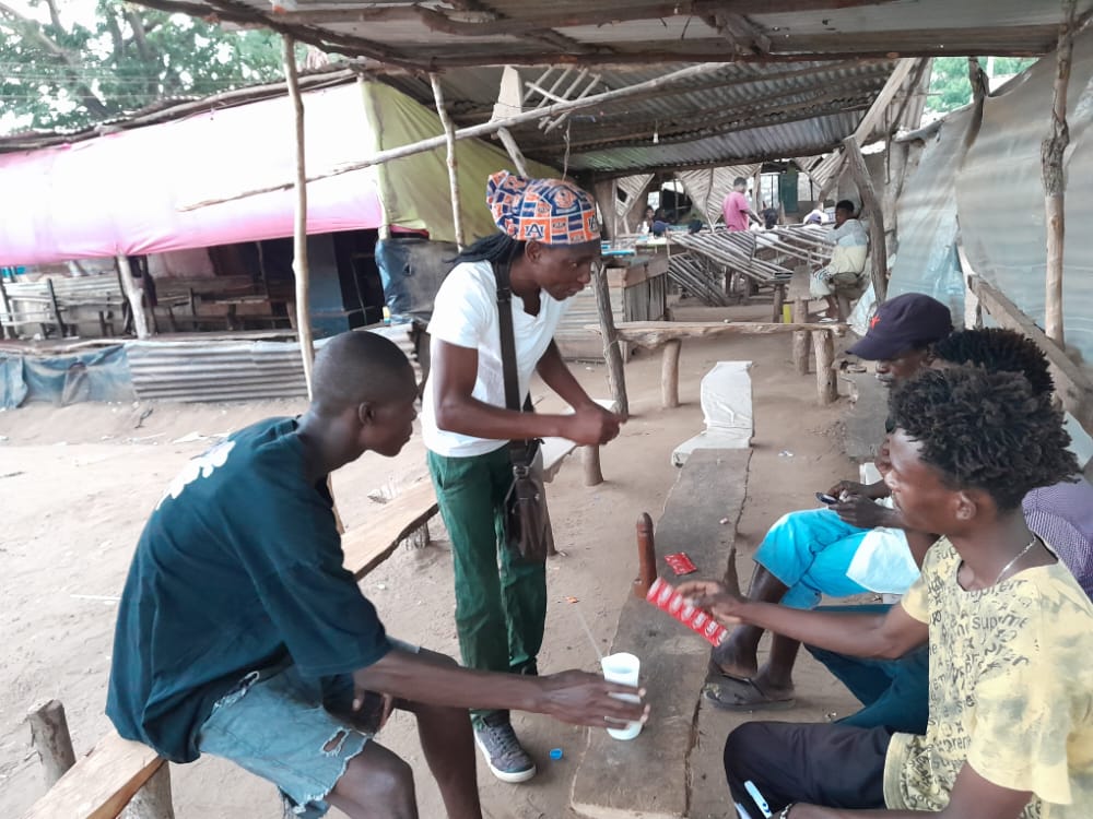 Peer Educator giving peers Sexual Health Education with a condom demonstration in an outreach activity after they're done testing for HIV. #hivprevention #HIVTesting