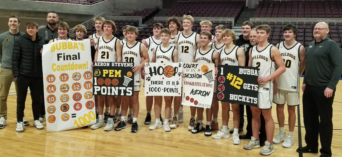 Aeron Stevens (12) celebrates with the Plainview-Elgin-Millville team after scoring his 1,000th career point in Saturday's 83-59 win over Rochester Lourdes.