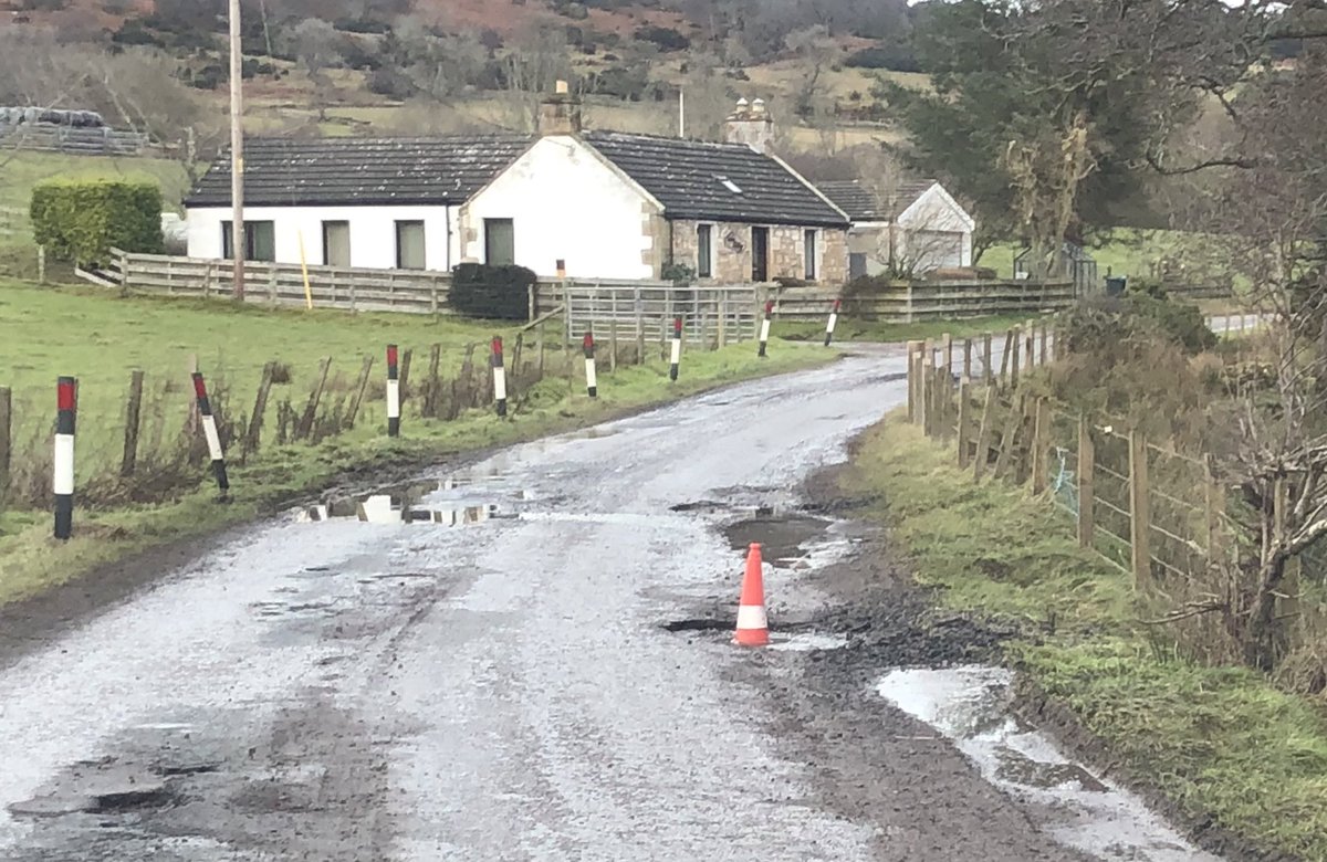 donald_lockhart's tweet photo. In #Scotsburn, the numerous potholes pose a risk  to cyclists, pedestrians and motorists alike but some public-spirited person has helpfully placed a traffic cone in one of the more egregious examples.  @HighlandCouncil https://t.co/TfldOiCDXY