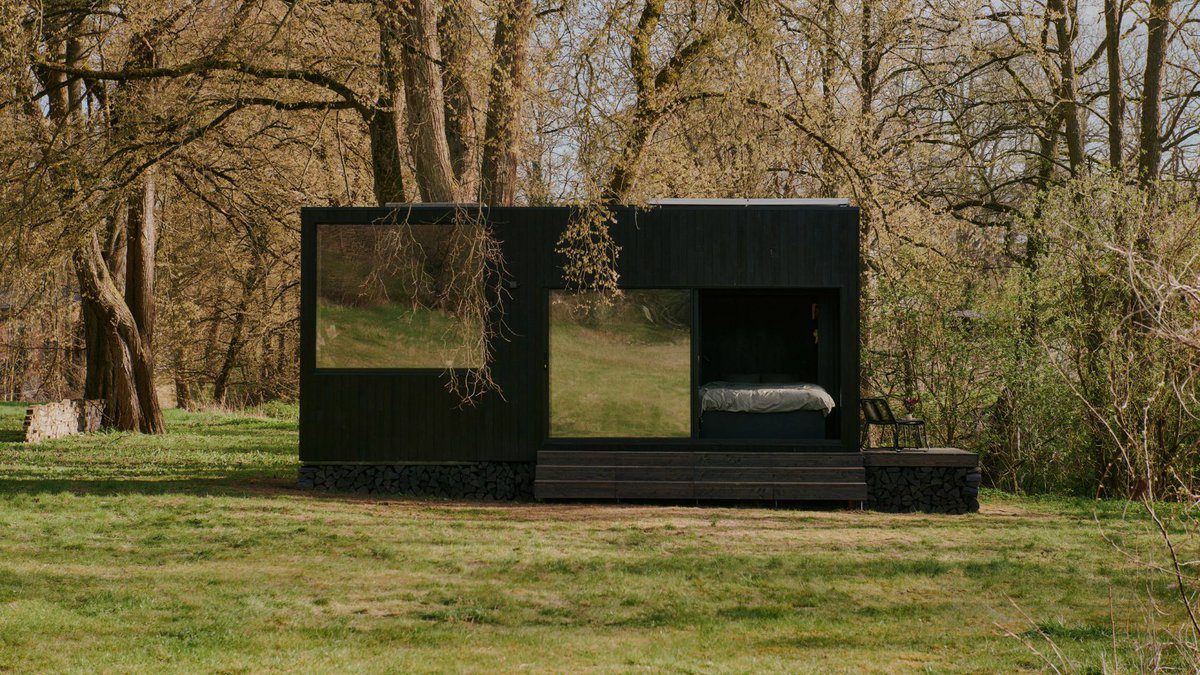 dezeen's tweet photo. Sigurd Larsen creates compact timber-clad cabin with panoramic windows: https://t.co/AdxLgzZuns https://t.co/iNnIz8BSHv