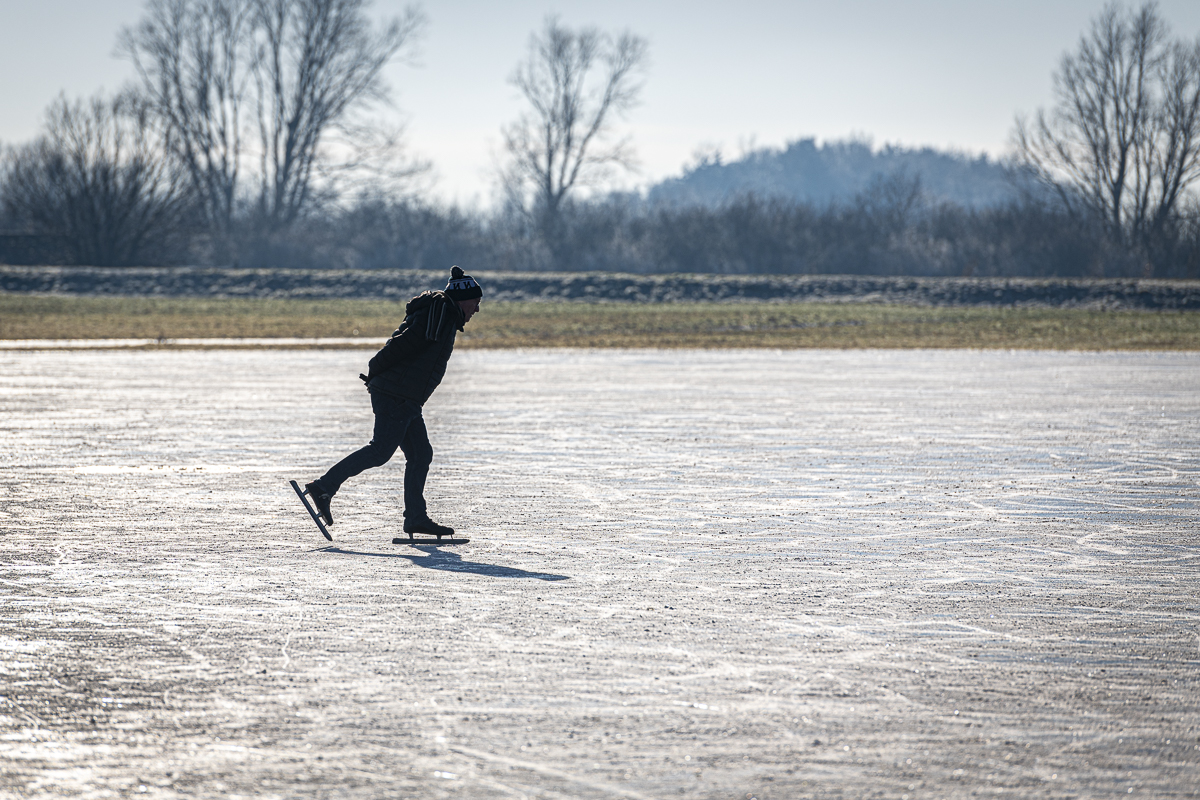 A lone fen skater heads out onto the ice in  the wide open Cambridgeshire Fens. #fens #fenskating #cambridgeshire #weather #winter #coldsnap #fenland #winter #uk #cambridgeshirefens #nikond850 #ice