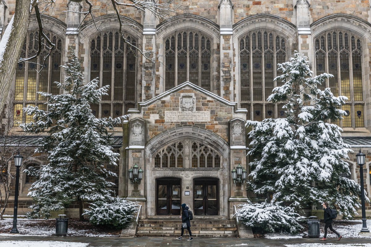 A student walks in front of the entrance to the Reading Room
