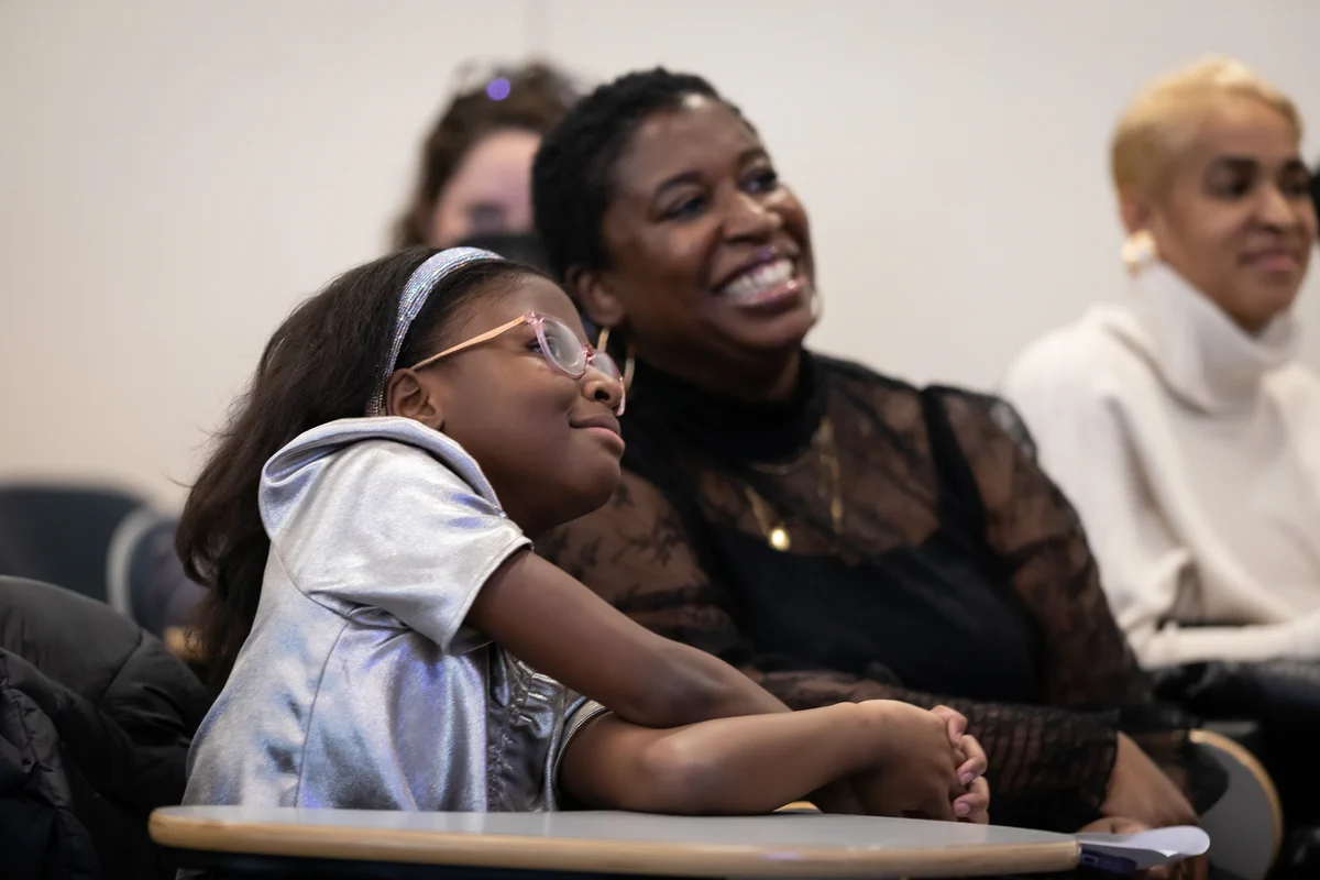 Bobbi Wilson and Monique Joseph watching a presentation
