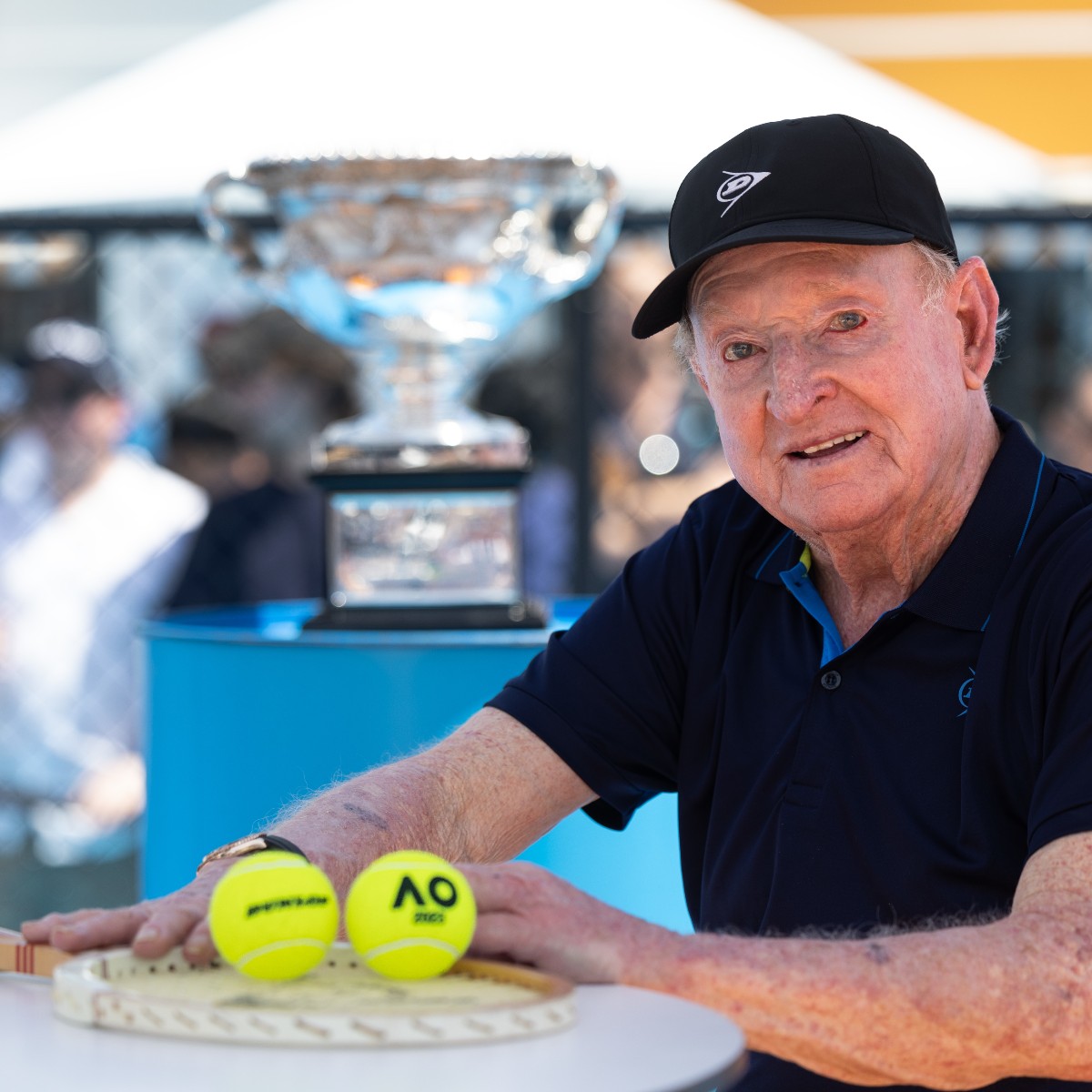 dunloptennis's tweet photo. It was an honour to have Rod Laver gracing the Australian Open again!
Rod took a trip down memory lane posing for photos with the AO trophy.
He answered some questions for the fans and signed some merchandise! A true legend of the game!
#TeamDunlop #RocketRod #AO2023 https://t.co/beCVJ0aq4J