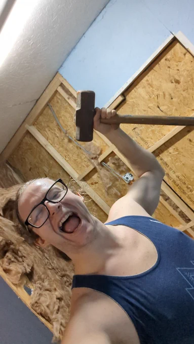 Me, boop, holding a sledgehammer and looking either fierce or ridiculous