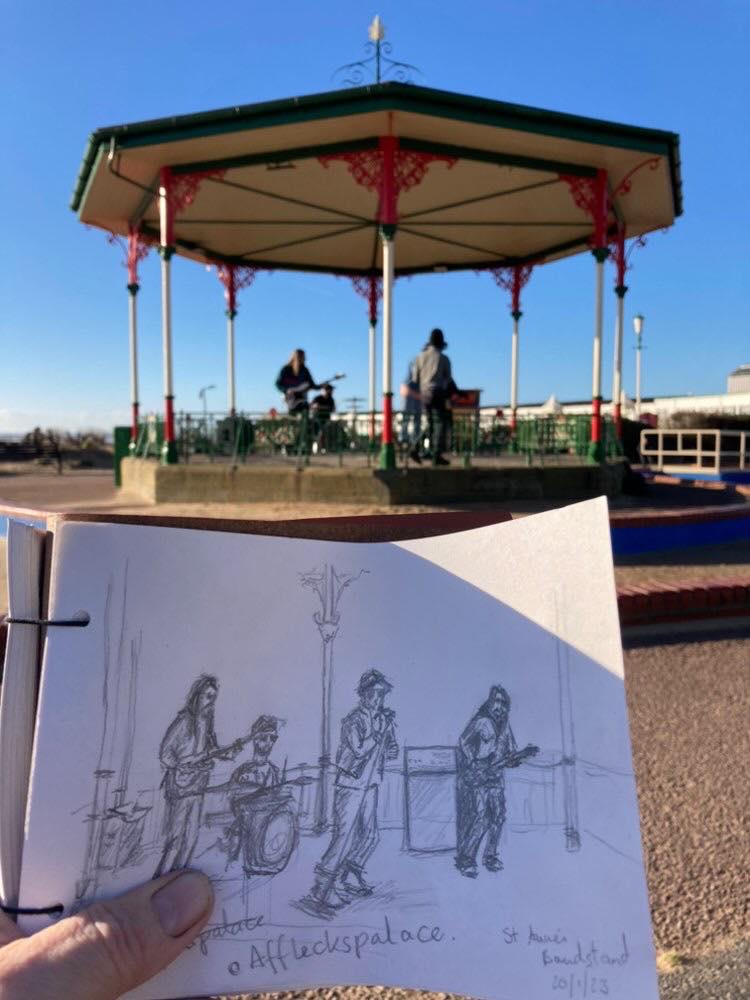 StAnnesTweetUp's tweet photo. An 'illustration' of how cool and arts-orientated this town is. Manchester-based band Afflecks Palace shot the video for their new single Holidays in and around our heritage bandstand. A passing artist sketched them in the act! #collab #stannesonsea #music #seaside #bandstand https://t.co/A7fYwzP6km