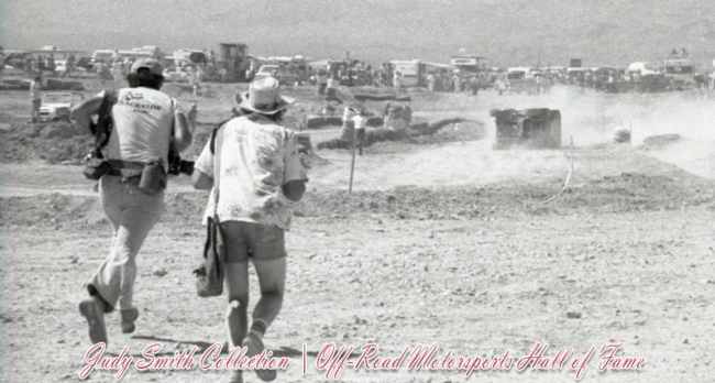 From the Judy Smith Collection at the Hall of Fame, future ORMHOF inductee Jim Ober of Trackside Photo (left) sprints to the scene of an overturned vehicle at a 1978 SCORE race in Las Vegas. View hundreds of historic images here: conta.cc/3XRJYK2