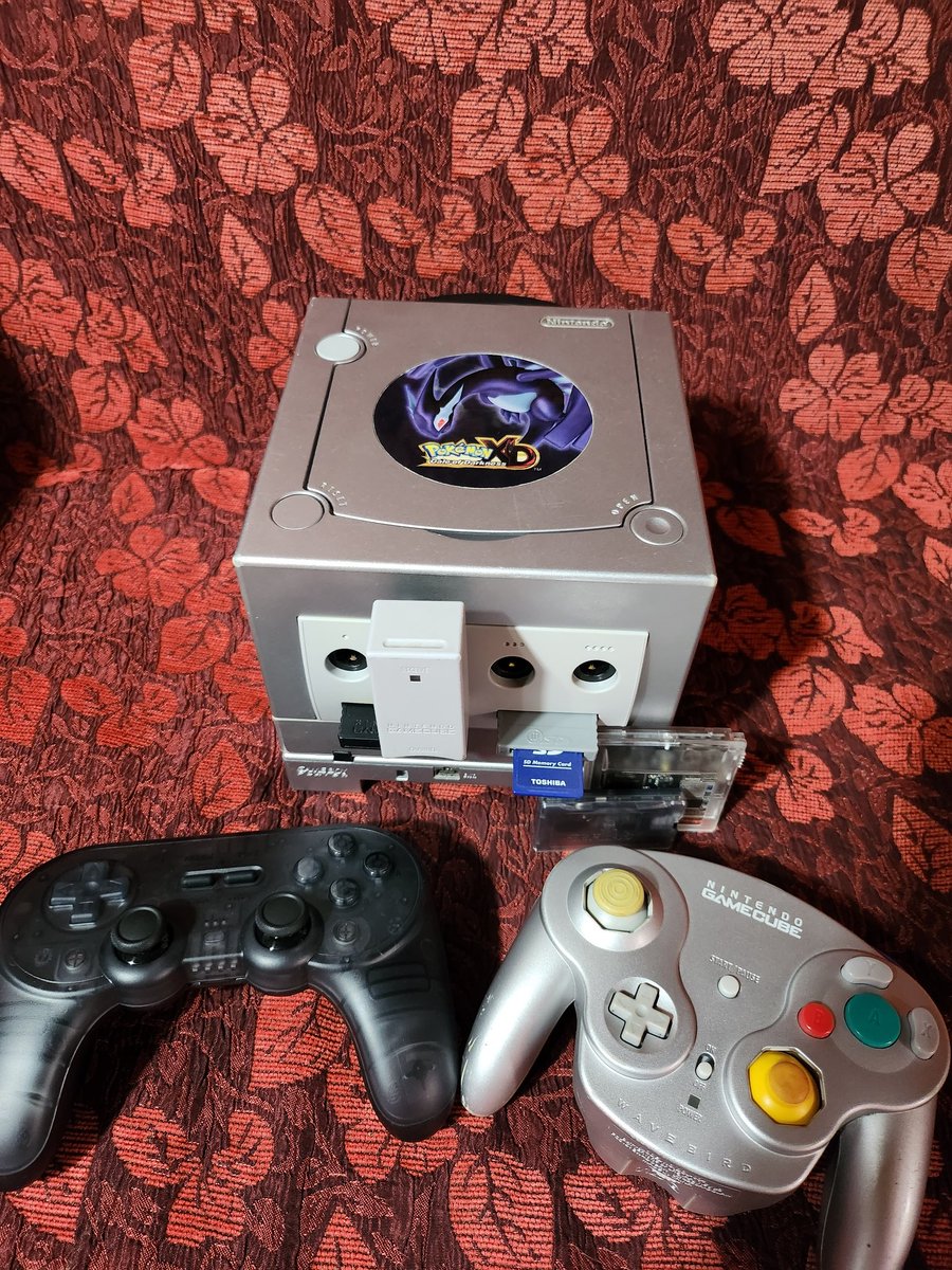 PressStartEC's tweet photo. The #GameCube is trending again.

An update to my modded Pokémon XD variant:
- Noiseblocker fan
- BlueRetro internal controller adapter
- 8bitdo SN30 pro 2 smoke black controller
- 512 Gb SD card https://t.co/fjAAZ1VwZL