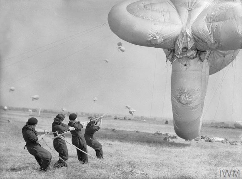 WomenAtWar2's tweet photo. 1/3 #WomensAuxiliaryAirForce #WAAF maintained & operated #barrageballoons as part of #RAF #ballooncommand in #WW2. Used to force enemy aircraft to fly higher, reducing bomb aiming accuracy,made aircraft change route into #antiaircraft fire or fly into the metal cables @WRAFBranch https://t.co/loEHS26rI3