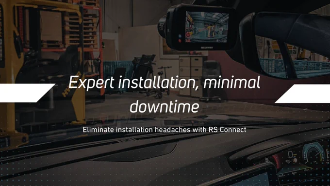 View from inside car, we can se that the vehicle is in a warehouse. We can also see a bit of the infotainment system and the black dashcam also showing front view. Text in white reads "Expert installation, minimal downtime"