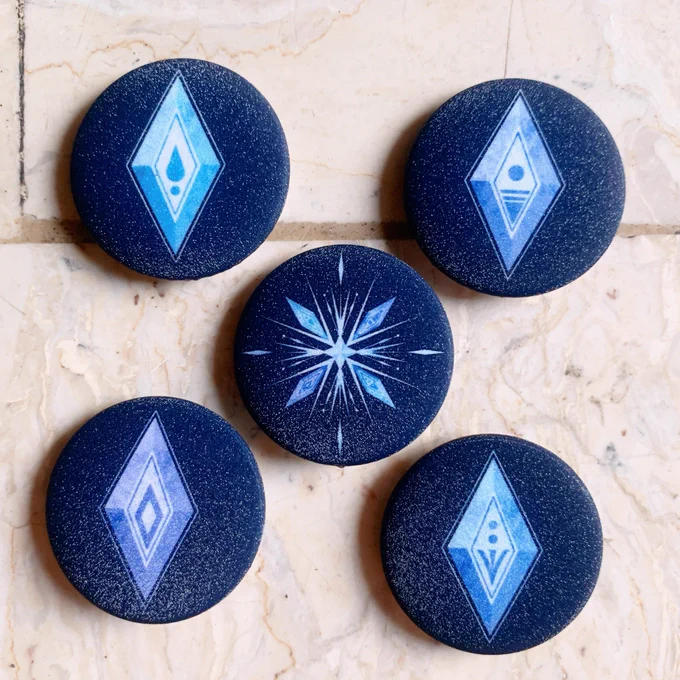 From my Frozen 2 collection, I'll be bringing over leftover 1-inch bubble sticker sets and 1-inch Element pins 
