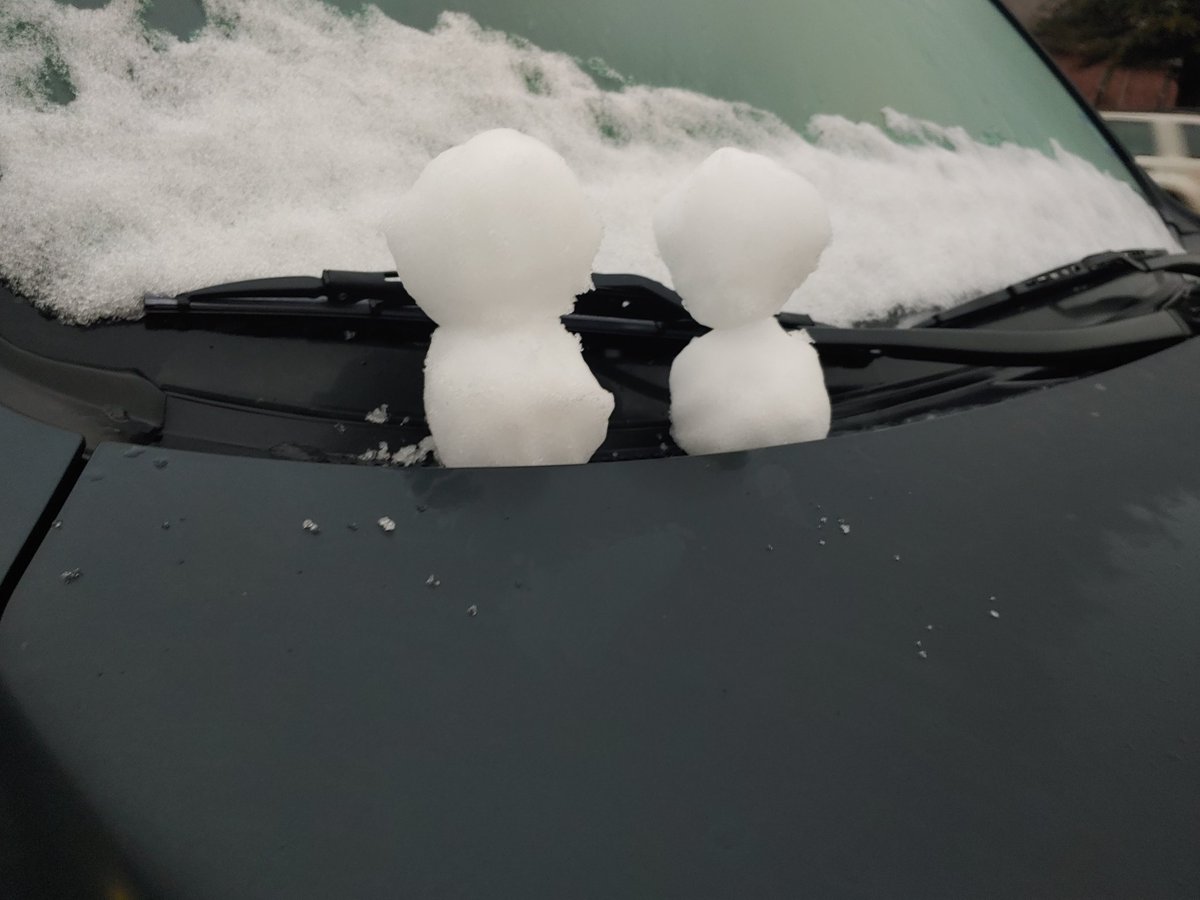 Woke up to just enough snow left over on my car this morning to put two little snowmen on my wife's hood while waiting for my car to warm up. #winter