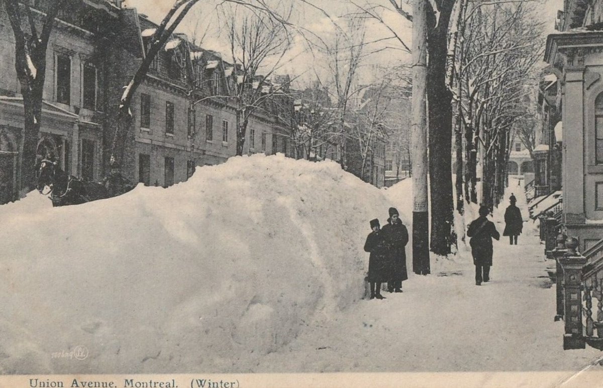What our streets looked like 100 years ago.  The snow was just shoveled to the side of the road and left there all winter.