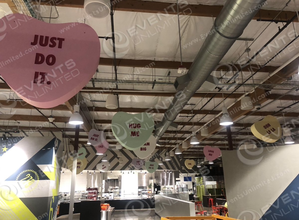 For this Valentines installation we crafted giant 4ft, 3ft, and 18inch candy hearts which we then rigged overhead.  A fun custom valentines day project and installation! #custominstall #valentinesday