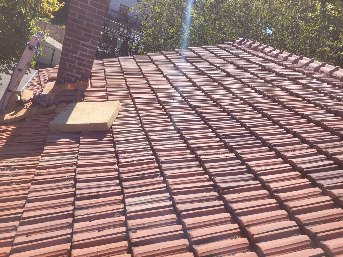 Tile roofing with copper chimney flashing. 
#roofing #roofleaks #stlouis