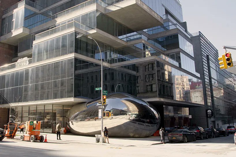 designboom's tweet photo. anish kapoor's newly completed 'bean' is snugly squeezed beneath the cantilevering slabs of the 'jenga building' at 56 leonard street in new york city. https://t.co/BSPdDkv2Ur https://t.co/m5UR9wGWcV