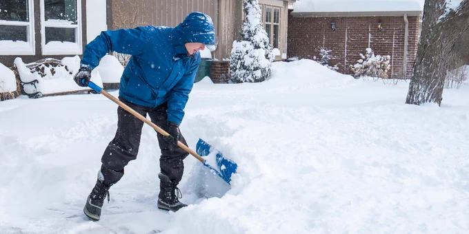 A senior adult shoveling snow