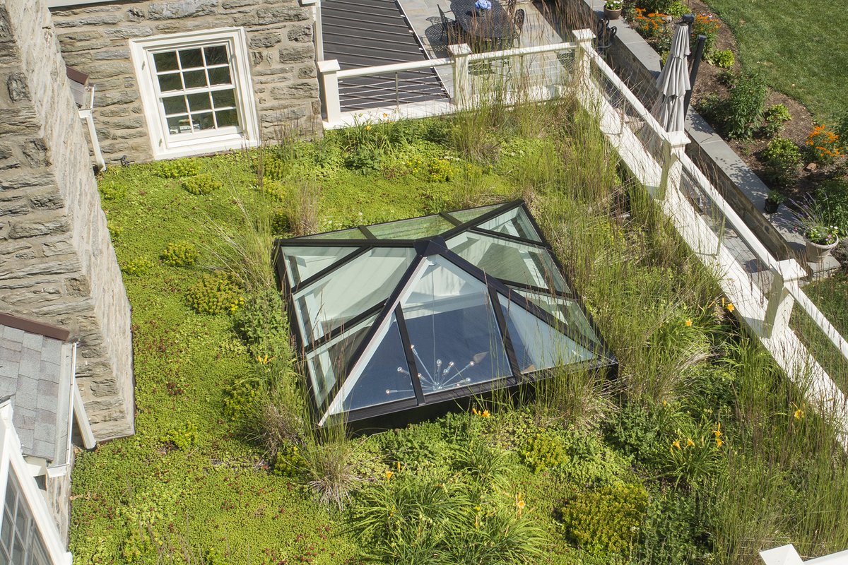 ACCENTUATING A GREEN SPACE.  This 7 ft. x 7 ft. pyramidal skylight has a white finish on the interior and dark bronze anodized finish on the exterior to complement the surrounding living roof - a beautiful addition, inside and out.  Contact a sales representative to learn more.