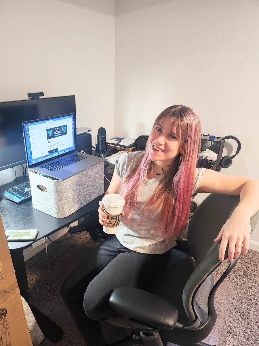 Paige next to a computer setup 