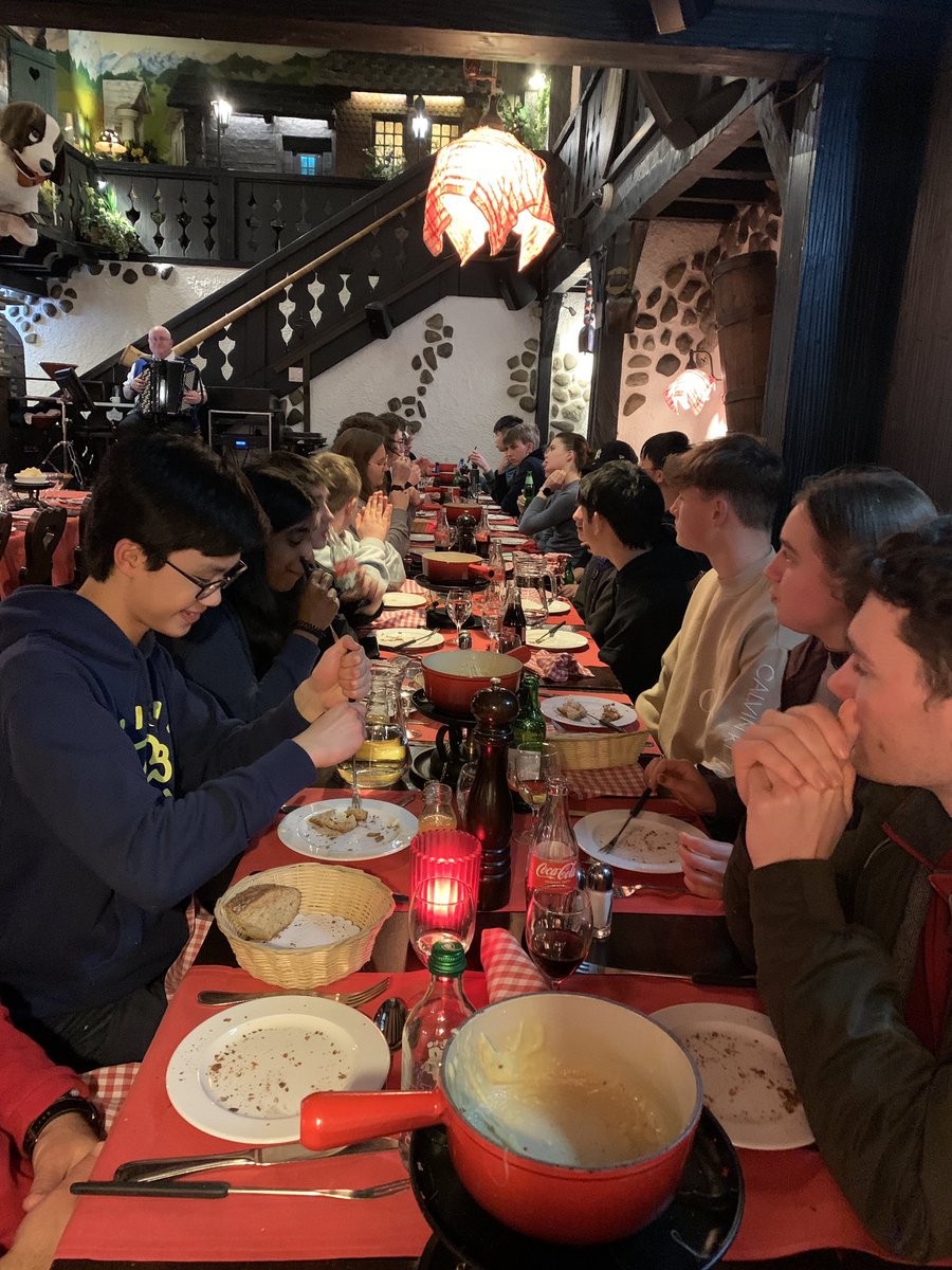 MonktonScience's tweet photo. Swiss cheese fondue 🫕 being enjoyed. Sausage and chips next up before ice cream 🍨 #CERN #MonktonPhysics #MonktonYear13 #MonktonYear12 @Edelweisshotel1 https://t.co/QDnIyteSvz