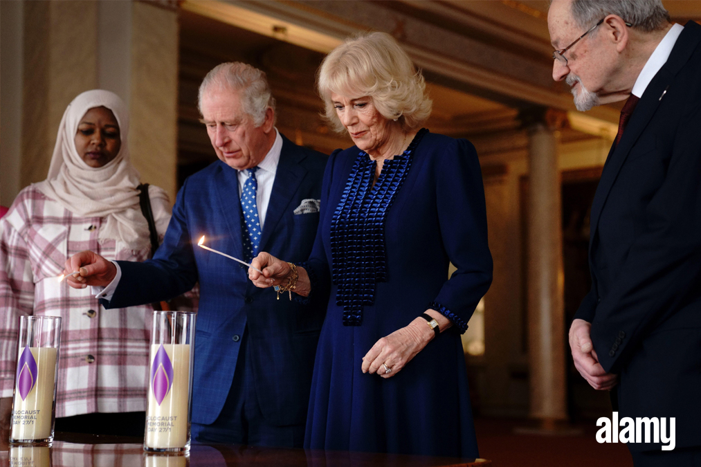 King Charles III and the Queen Consort light two candles at Buckingham Palace, London, to mark Holocaust Memorial Day, alongside Amouna Adam, a survivor of the Darfur genocide, and Holocaust survivor Dr Martin Stern . Image ID: 2MHR7W1 // Victoria Jones // PA Wire