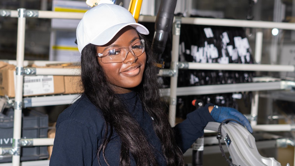 Rivian's tweet photo. We recently added a second shift at our plant, which means we can build vehicles around the clock and continue to ramp production. Follow the link to experience life on the night shift through the eyes of Junior, a team member in General Assembly: https://t.co/EntpsDX7mf https://t.co/B2ih4qe1Uf