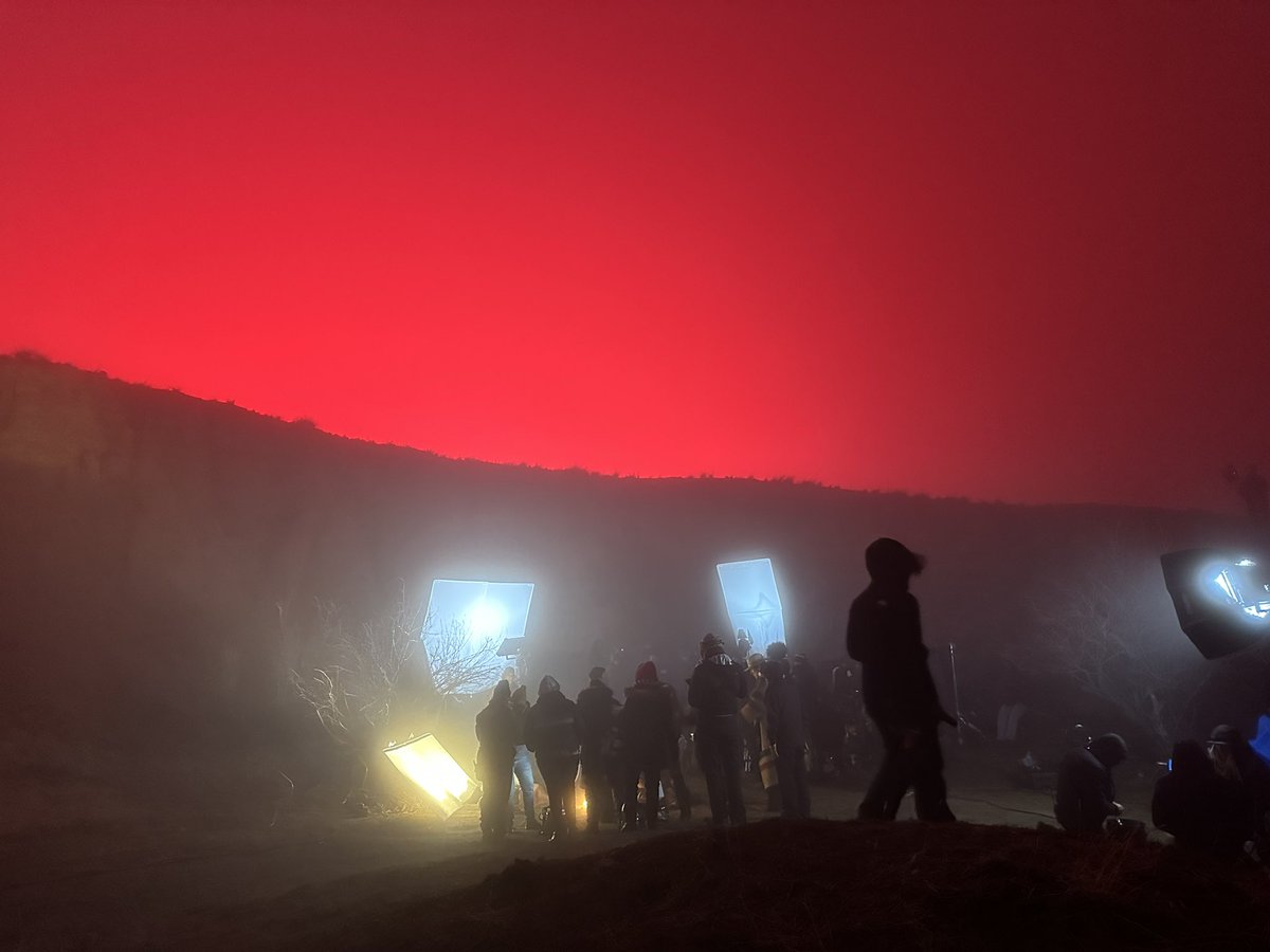 CodyRossGray's tweet photo. We had an insane fog roll in as we were filming last week. It was bad enough that we had to stop mid-scene. So our awesome lighting team turned moonlight red while some of our crew huddled around the sfx campfire. Gave off major #Mandy vibes. #red #onsetVFX #VFX #1923tv https://t.co/yIynEdrGQ1