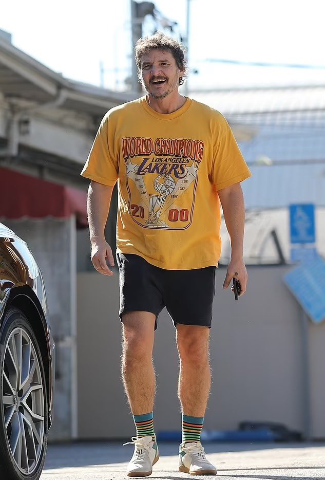 Pedro Pascal dashes down sidewalk in vintage Lakers T-shirt