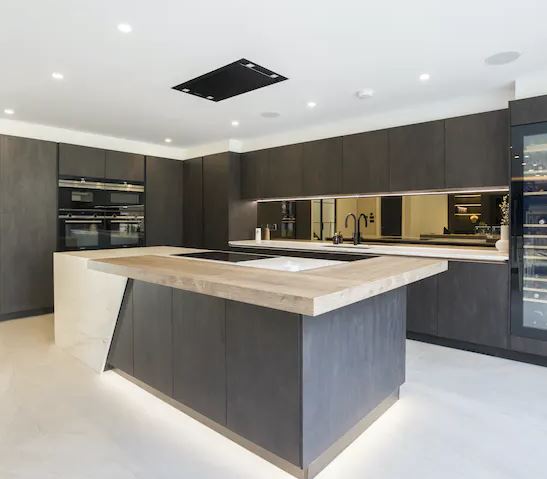This striking kitchen island combines Dekton and wood to create a standout, unique look. Dekton is used as cladding to create this beautiful waterfall design. Visit our showroom to discuss your new kitchen today. #dekton #horsham #interiordesign #waterfalledge #worktops