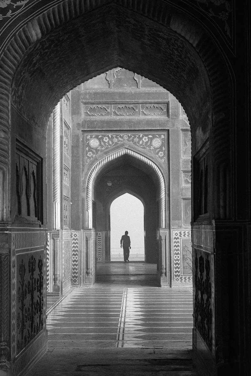 In the early morning, cleaners work on the grounds of the Taj Mahal, sweeping and polishing floors and dusting crevices ready for the hordes of visitors that come through the gates each day.