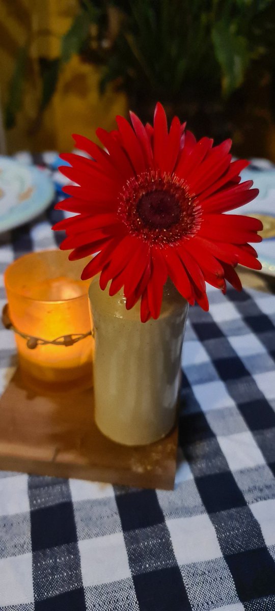 #Simplebeauty, a #tablecenterpiece with votive and gorgeous #crimsonred #daisy picked from the #garden