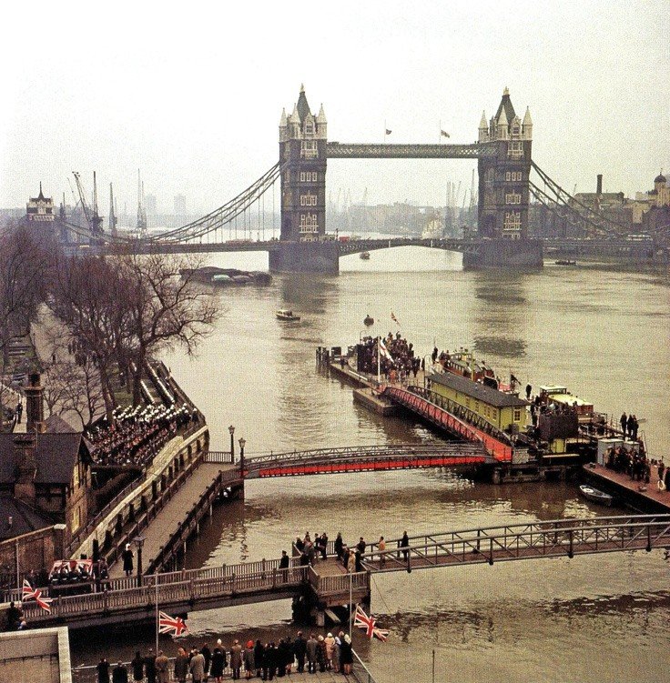 30 January 1965, the flag-draped coffin of Sir Winston Churchill is carried to the Port of London Authority launch 'Havengore' at Tower Pier.