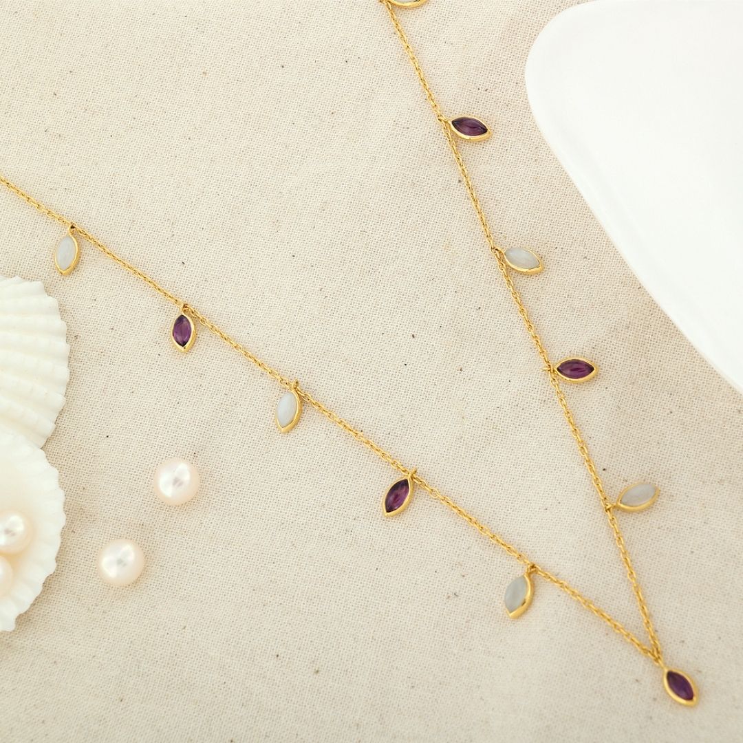 Amethyst and moonstone come together to form a design that can be worn as it is or as a part of a layered look to create a dramatic effect.

#amethyst #moonstone #whitemoonstone #marquise #stationnecklace #minimaljewelry #handmade