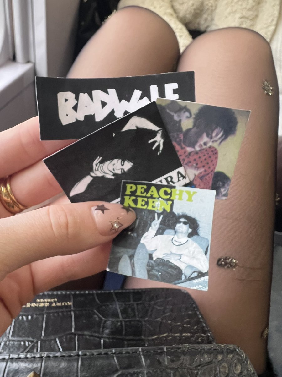 random act of #curefan kindness.. singing ‘jumping someone’s plane’ in Manchester airport this morning and a kind stranger handed us these stickers. Didn’t get to say thank you! 👎🏻 #thecure <a href="/RobertSmith/">ROBERT SMITH</a>