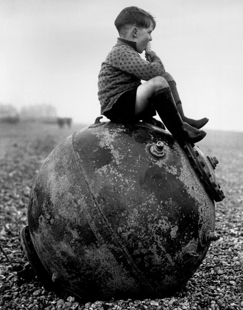 #MineWarfare Boy sitting on a sea mine, Kent, England, 1940.