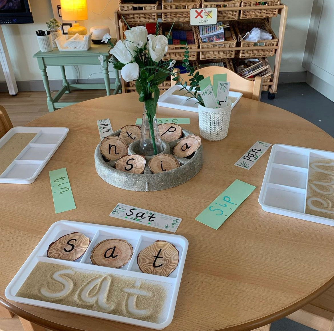 A great sensory pre-writing activity! Students practice their words by spelling first with the word tiles and then write their word with their finger in the sand! <a href="/PJLanguageArts/">PJ Language Arts Methodology UWindsor</a>