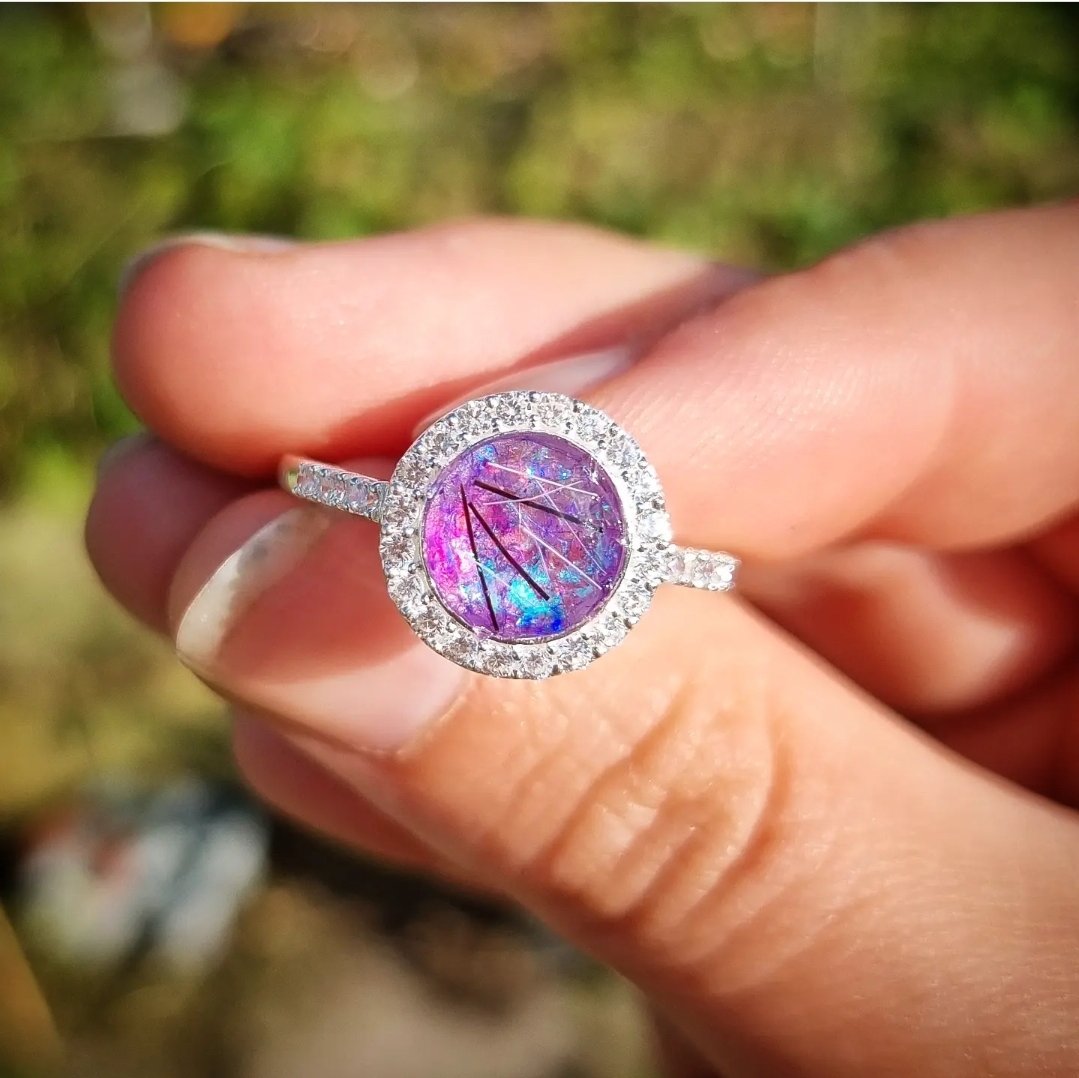 Stunning halo ring with CZ crystals.
Enclosed within is the hair of a beloved horse, complemented with purple iridescent flakes.
#foryou #jewellery #foreverkeepsakes #memorialjewellery