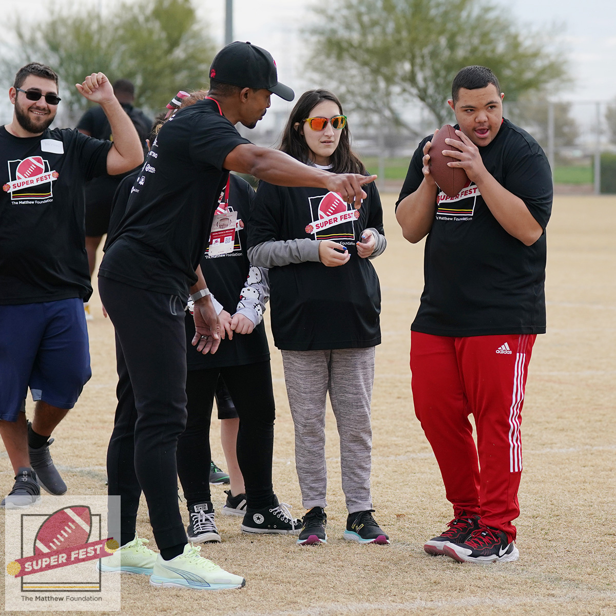 thematthewfdn's tweet photo. @StanfordFball alums @gmilburn and Luke Powell coach up players of all abilities and disabilities at #SuperFest2023 during #SuperBowl Saturday. #SuperBowlSunday #SBLVII #SuperBowlLVII  #NFL  #Football #downsyndrome #autism #disability  #inclusion #inclusive #stanford #Pac12 https://t.co/BHTORfs6WI