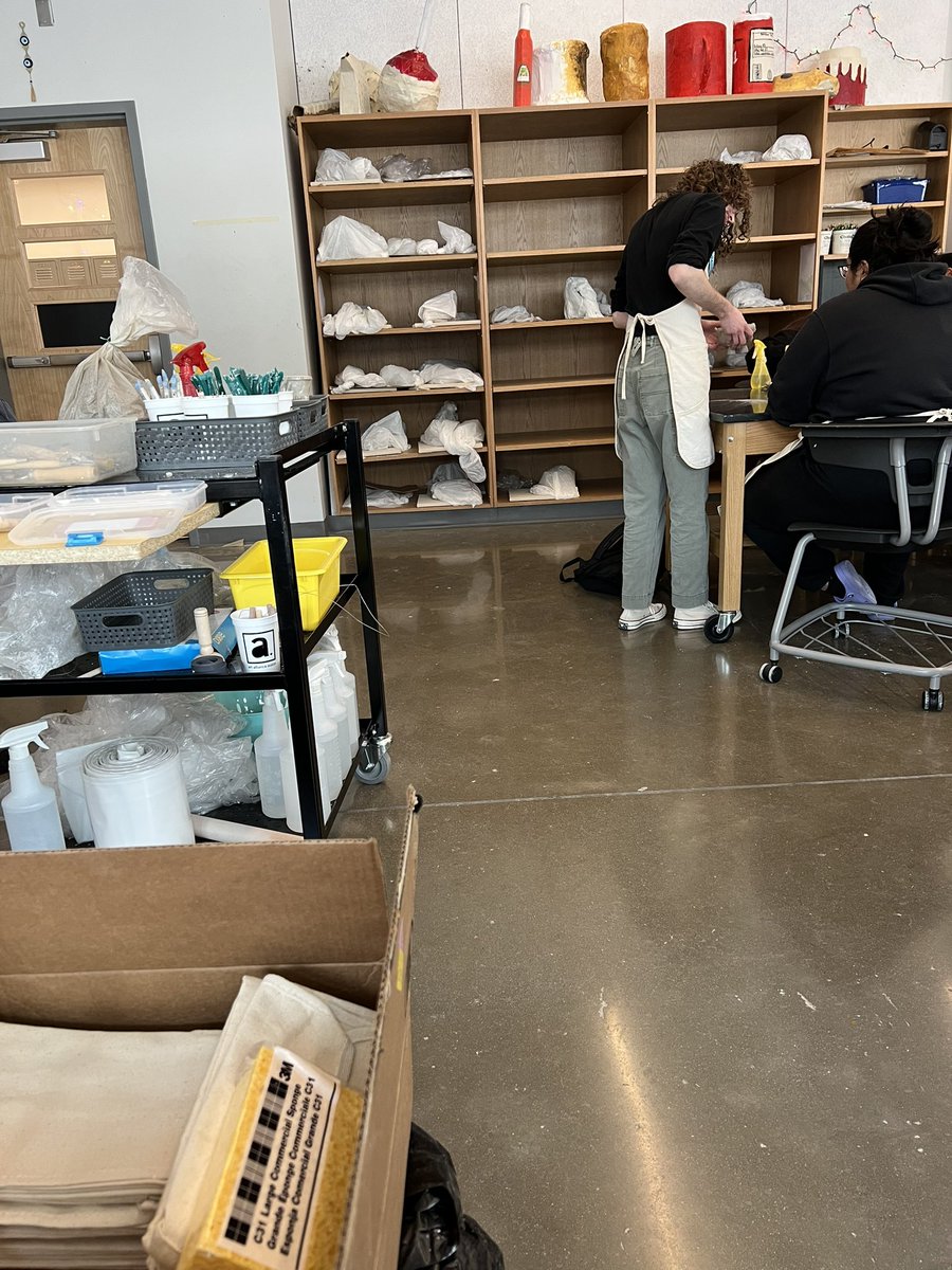 Teacher in action of inspecting a student’s clay sculpture before the next step of being fired in the kiln <a href="/EastsideECHS/">Eastside ECHS</a> <a href="/CKenderEDU/">Caitlin Kender</a> <a href="/AustinISD/">Austin ISD</a>